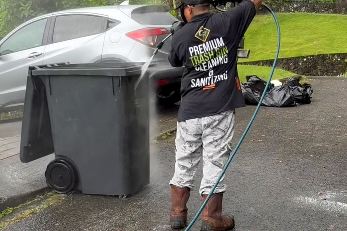 Clean Route Systems technician cleaning a residential trash bin on Oʻahu